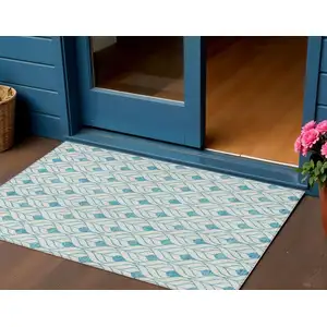Photo of Teal Blue And Ivory Geometric Washable Indoor Outdoor Area Rug