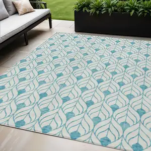 Photo of Teal Blue And Ivory Geometric Washable Indoor Outdoor Area Rug