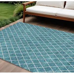 Photo of Teal Blue And Ivory Geometric Washable Indoor Outdoor Area Rug