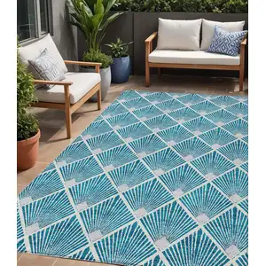 Photo of Teal Blue And Ivory Geometric Washable Indoor Outdoor Area Rug