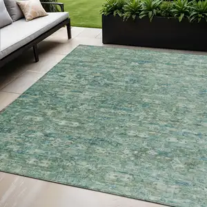 Photo of Teal Blue And Ivory Ikat Washable Indoor Outdoor Area Rug
