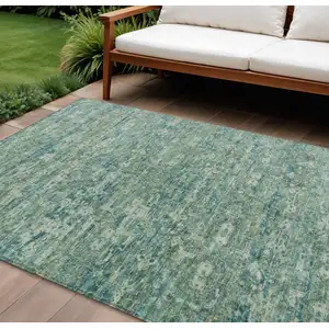 Photo of Teal Blue And Ivory Ikat Washable Indoor Outdoor Area Rug