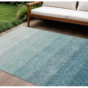 Photo of Teal Blue And Ivory Ombre Washable Indoor Outdoor Area Rug
