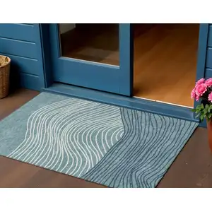 Photo of Teal Blue And Ivory Striped Washable Indoor Outdoor Area Rug