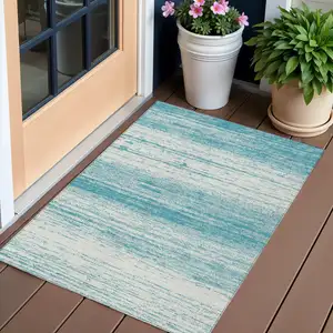 Photo of Teal Blue And Ivory Striped Washable Indoor Outdoor Area Rug