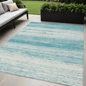 Photo of Teal Blue And Ivory Striped Washable Indoor Outdoor Area Rug