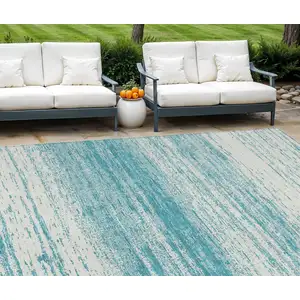 Photo of Teal Blue And Ivory Striped Washable Indoor Outdoor Area Rug