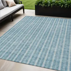 Photo of Teal Blue And Ivory Striped Washable Indoor Outdoor Area Rug