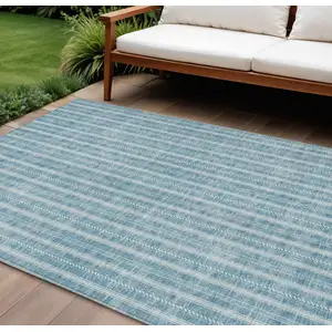 Photo of Teal Blue And Ivory Striped Washable Indoor Outdoor Area Rug