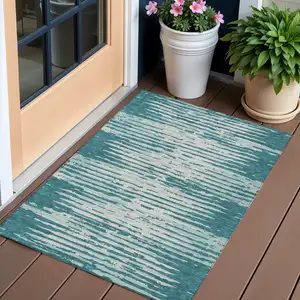 Photo of Teal Blue And Ivory Striped Washable Indoor Outdoor Area Rug