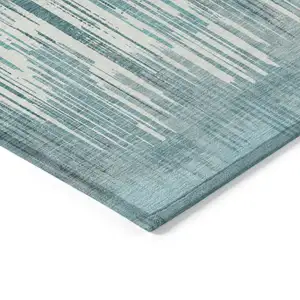 Photo of Teal Blue And Ivory Striped Washable Indoor Outdoor Area Rug
