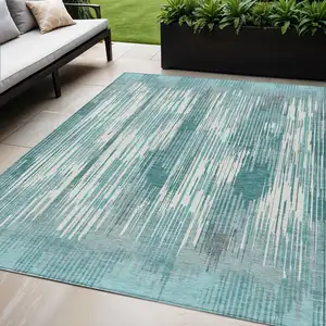 Photo of Teal Blue And Ivory Striped Washable Indoor Outdoor Area Rug