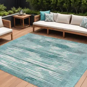 Photo of Teal Blue And Ivory Striped Washable Indoor Outdoor Area Rug