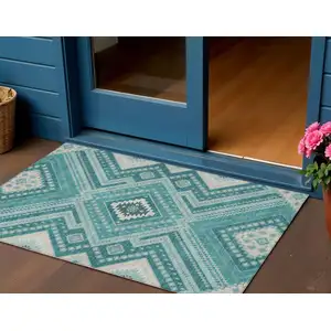 Photo of Teal Blue And Ivory Tribal Washable Indoor Outdoor Area Rug