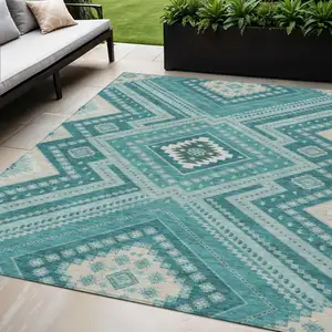 Photo of Teal Blue And Ivory Tribal Washable Indoor Outdoor Area Rug