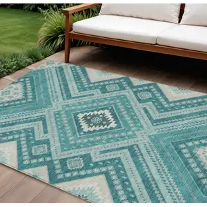 Photo of Teal Blue And Ivory Tribal Washable Indoor Outdoor Area Rug