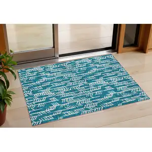 Photo of Teal Blue And Ivory Tribal Washable Indoor Outdoor Area Rug
