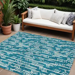 Photo of Teal Blue And Ivory Tribal Washable Indoor Outdoor Area Rug