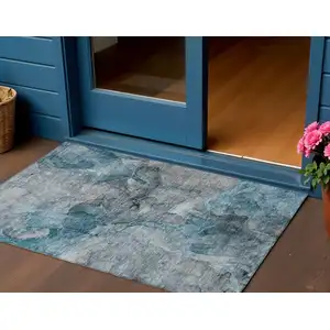 Photo of Teal Blue And Navy Blue Abstract Washable Indoor Outdoor Area Rug