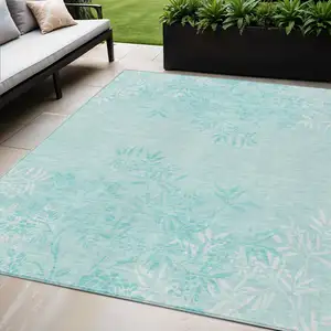Photo of Teal Blue Aqua And Ivory Floral Washable Indoor Outdoor Area Rug