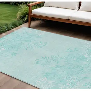 Photo of Teal Blue Aqua And Ivory Floral Washable Indoor Outdoor Area Rug