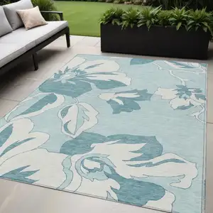 Photo of Teal Blue Aqua And Ivory Floral Washable Indoor Outdoor Area Rug