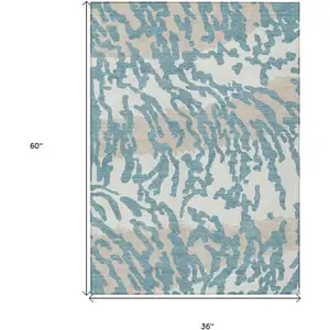 Photo of Teal Blue Beige And Ivory Animal Print Washable Indoor Outdoor Area Rug