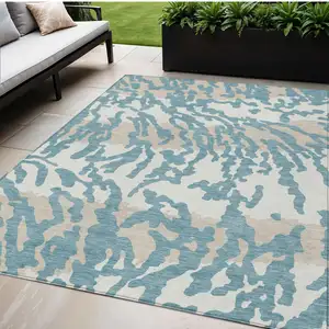 Photo of Teal Blue Beige And Ivory Animal Print Washable Indoor Outdoor Area Rug