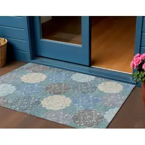 Photo of Teal Blue Beige And Ivory Quatrefoil Washable Indoor Outdoor Area Rug