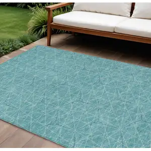 Photo of Teal Blue Black And Ivory Geometric Washable Indoor Outdoor Area Rug