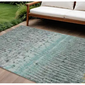 Photo of Teal Blue Gold And Gray Abstract Washable Indoor Outdoor Area Rug
