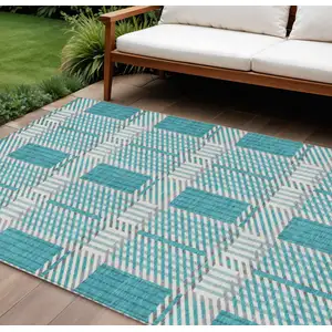 Photo of Teal Blue Gray And Ivory Plaid Washable Indoor Outdoor Area Rug