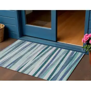 Photo of Teal Blue Gray And Ivory Striped Washable Indoor Outdoor Area Rug