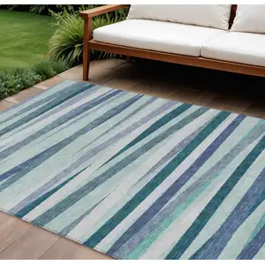 Photo of Teal Blue Gray And Ivory Striped Washable Indoor Outdoor Area Rug