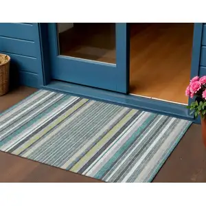 Photo of Teal Blue Gray And Ivory Striped Washable Indoor Outdoor Area Rug