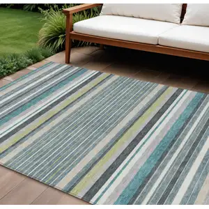 Photo of Teal Blue Gray And Ivory Striped Washable Indoor Outdoor Area Rug