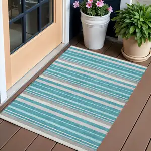 Photo of Teal Blue Gray And Ivory Striped Washable Indoor Outdoor Area Rug
