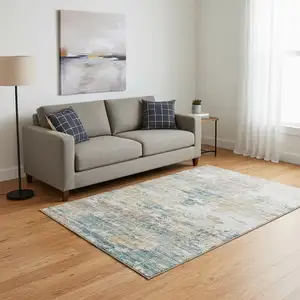 Photo of Teal Blue Ivory And Copper Abstract Washable Area Rug With UV Protection