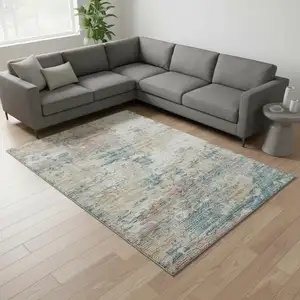 Photo of Teal Blue Ivory And Copper Abstract Washable Area Rug With UV Protection