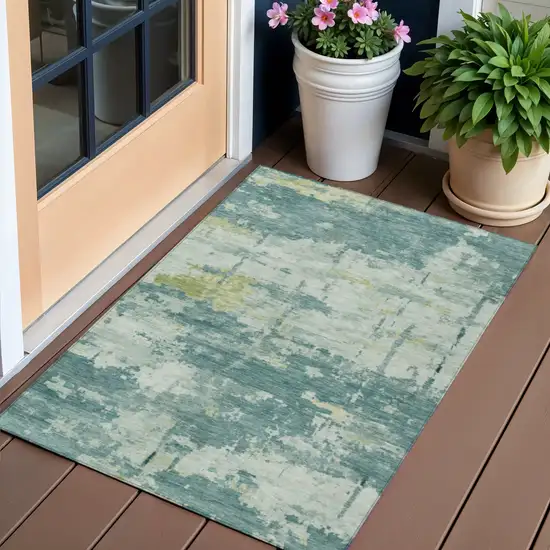Teal Blue Ivory And Gold Abstract Washable Indoor Outdoor Area Rug Photo 1