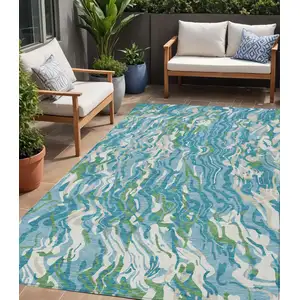 Photo of Teal Blue Ivory And Green Abstract Washable Indoor Outdoor Area Rug