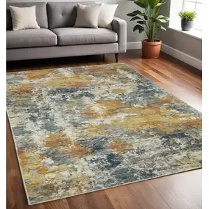 Photo of Teal Blue Orange Gold Grey Tan Brown And Beige Abstract Printed Stain Resistant Non Skid Area Rug