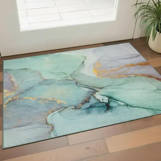 Teal Gold And Ivory Abstract Washable Area Rug With UV Protection Photo 1