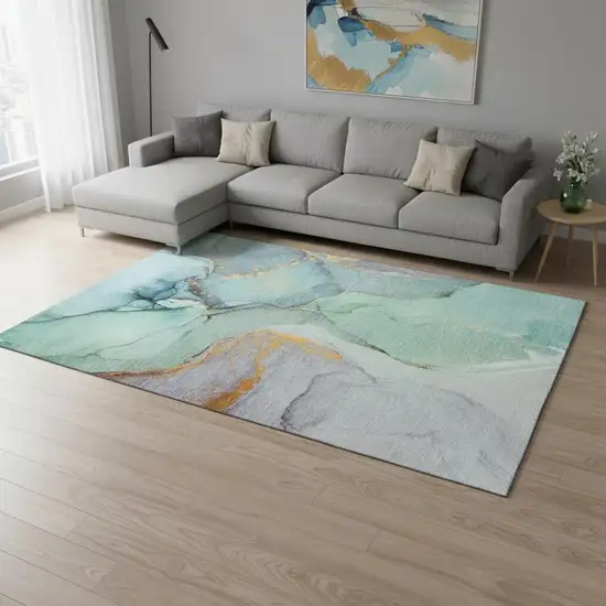 Teal Gold And Ivory Abstract Washable Area Rug With UV Protection Photo 1