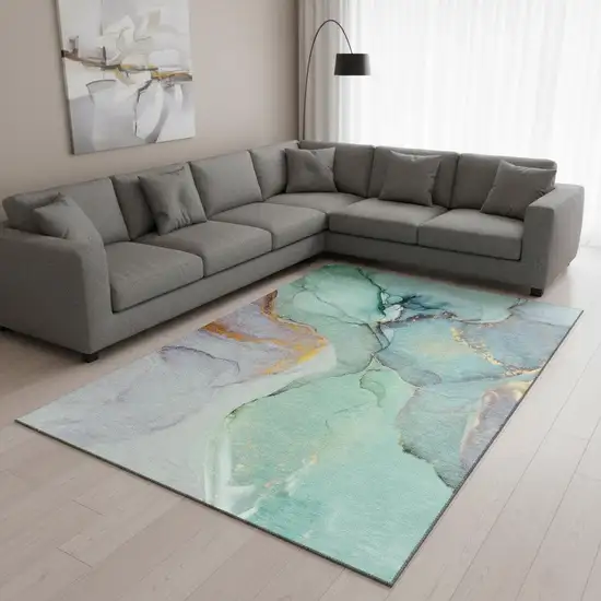 Teal Gold And Ivory Abstract Washable Area Rug With UV Protection Photo 1