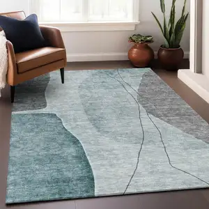 Photo of Teal Gray And Ivory Abstract Washable Area Rug With UV Protection