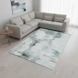 Photo of Teal Gray And Ivory Abstract Washable Area Rug With UV Protection