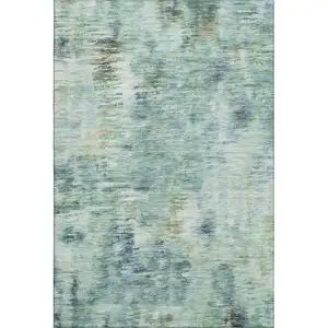 Photo of Teal Green And Ivory Abstract Washable Area Rug With UV Protection