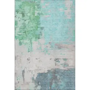 Photo of Teal Green And Ivory Abstract Washable Area Rug With UV Protection