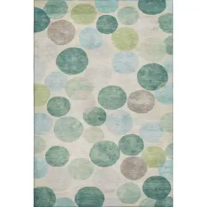 Photo of Teal Green And Ivory Geometric Washable Area Rug With UV Protection